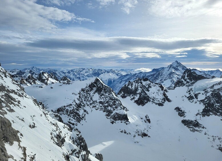 A snow-covered mountain range with sharp peaks and a clear sky. 2