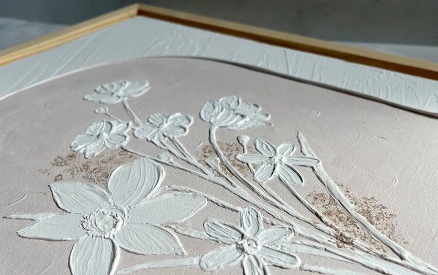 A close-up of a textured surface with embossed floral patterns. 3