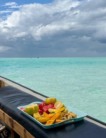 A tropical beach with a clear view of the turquoise sea and a stormy sky. 3
