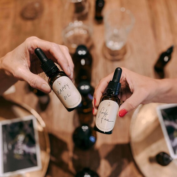 Two hands holding bottles labeled 'happy oil' and 'fresh face.' 4