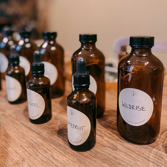 Several small brown glass bottles with labels on a wooden surface. 2