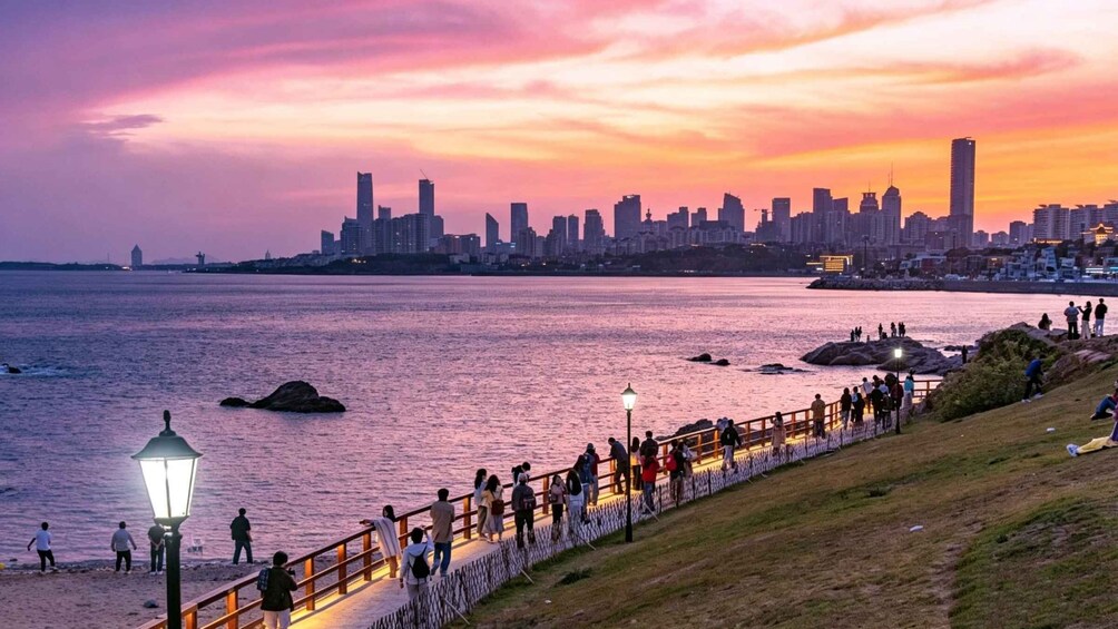 A sunset over a city skyline with a waterfront promenade. 3