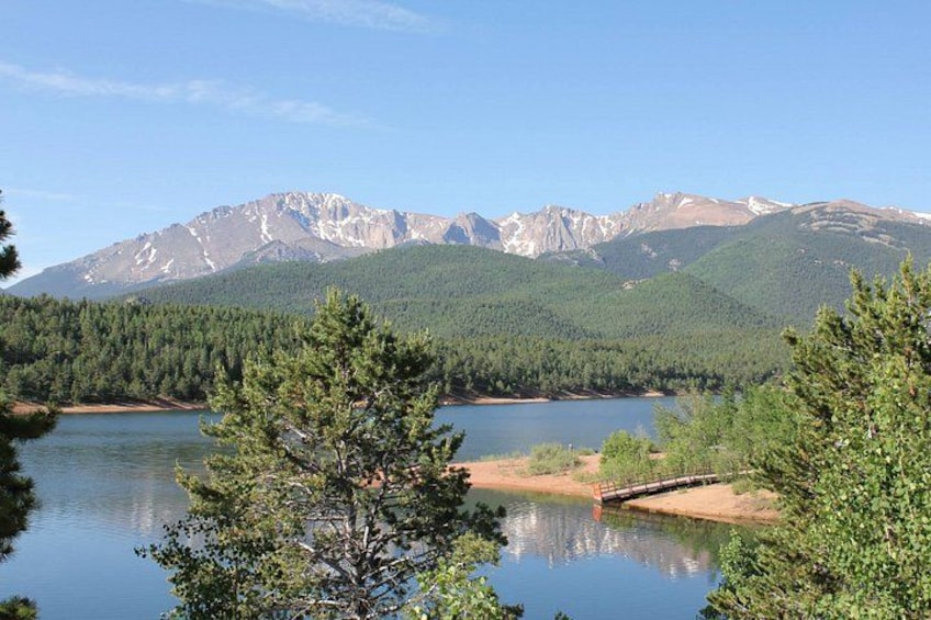 A lake surrounded by dense forest and mountains. 3