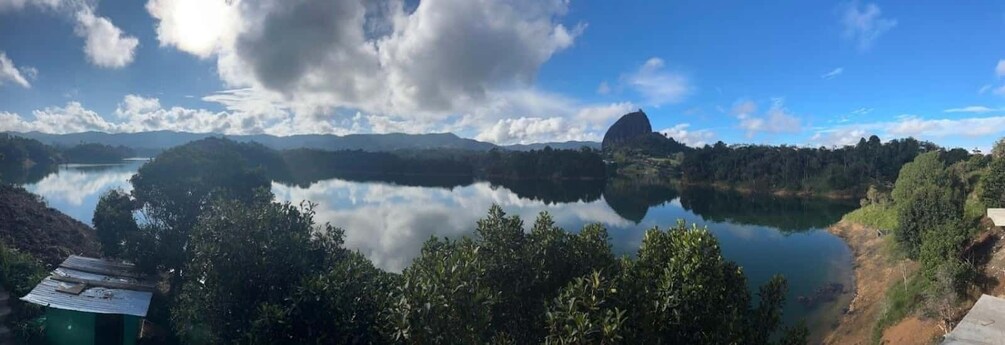 A lake surrounded by mountains and trees. 3