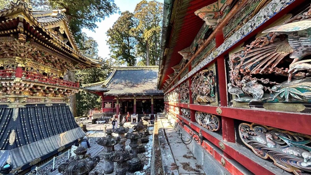 A traditional temple with ornate architecture, a central building, and a stone pathway leading to it. 3