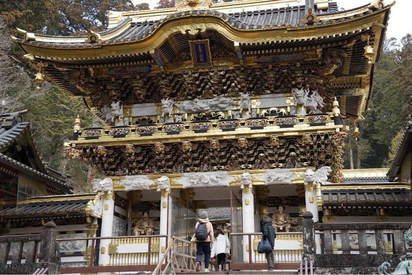 A traditional ornate temple with golden accents and statues. 4