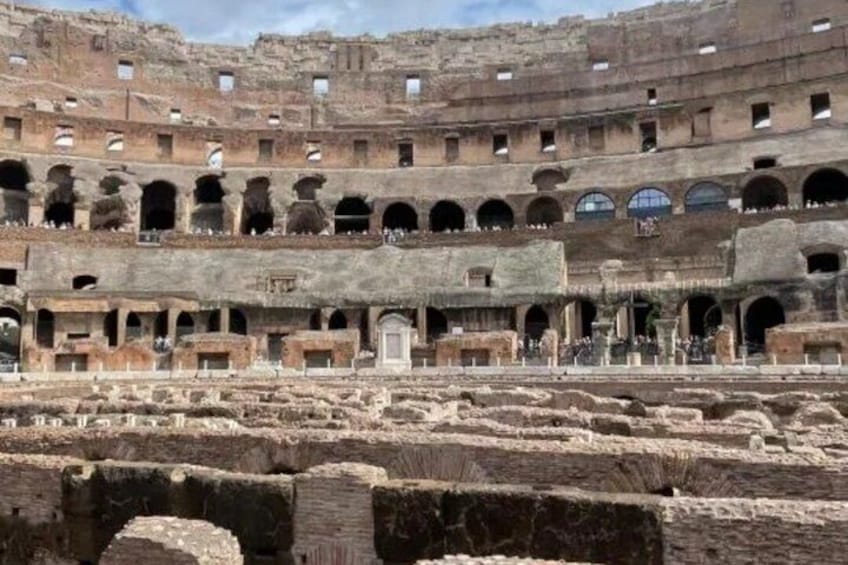 An ancient Roman amphitheater with multiple levels of arches and ruins. 4