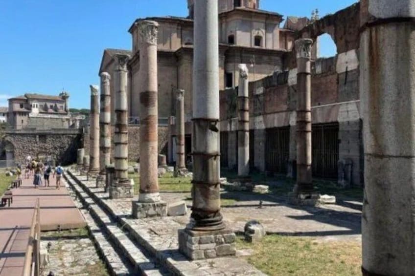 Ancient ruins with columns and a pathway. 2