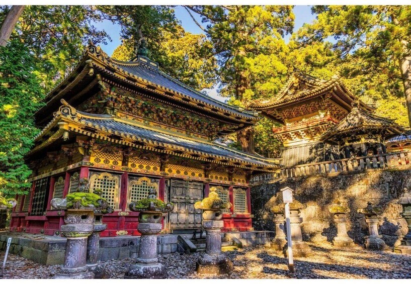 A traditional Japanese temple with ornate architecture, surrounded by lush greenery. 5