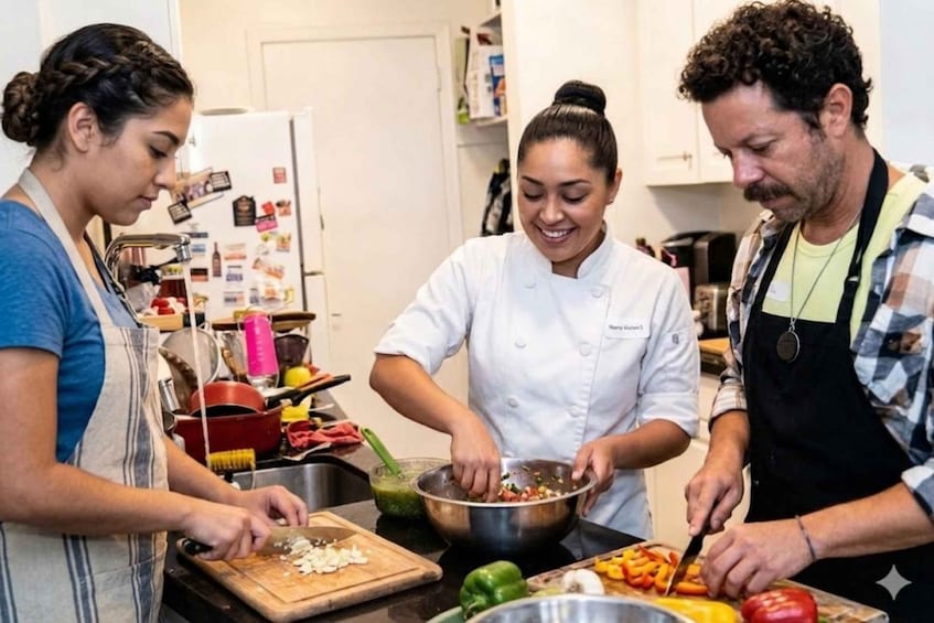 A kitchen with four people preparing food. 1