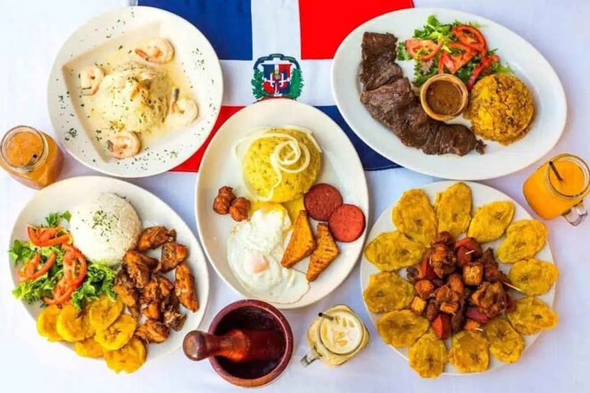A table with various plates of food, including rice, eggs, meat, and plantains. 2