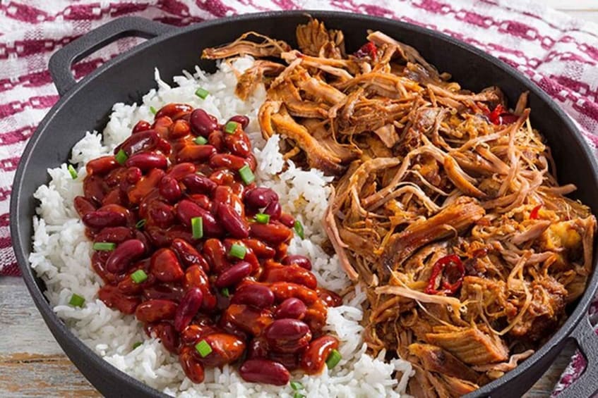 A skillet with white rice, red kidney beans, and shredded meat. 3
