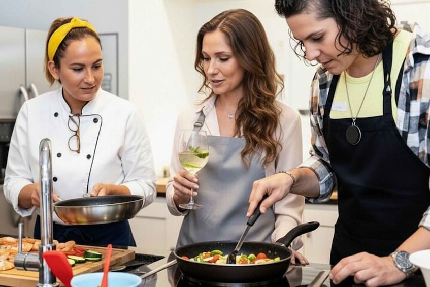 Three people cooking in a kitchen. 5