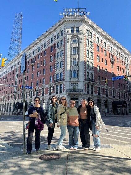 A group of people standing in front of the Hotel Lafayette building. 3