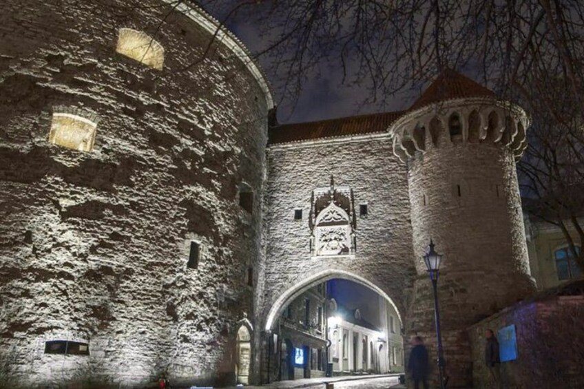 A historic stone building with a round tower and an arched entrance. 1