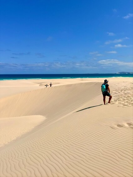 A desert landscape with sand dunes and a clear blue sky. 5