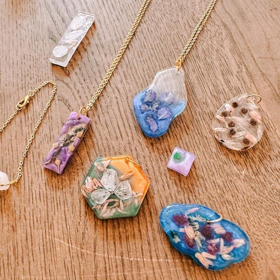Various colorful resin pendants on a wooden surface. 4