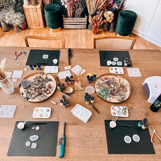 A crafting table with art supplies, including paint, brushes, and decorative items. 1