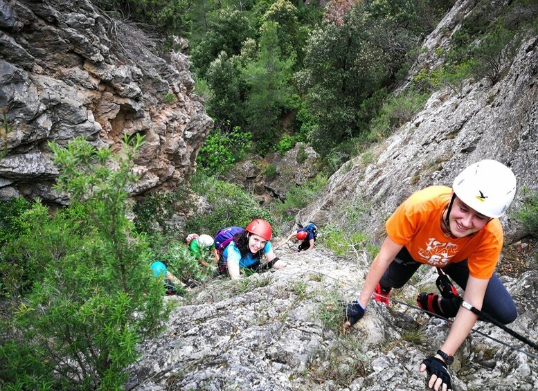 A group of people climbing a rocky mountain path. 1