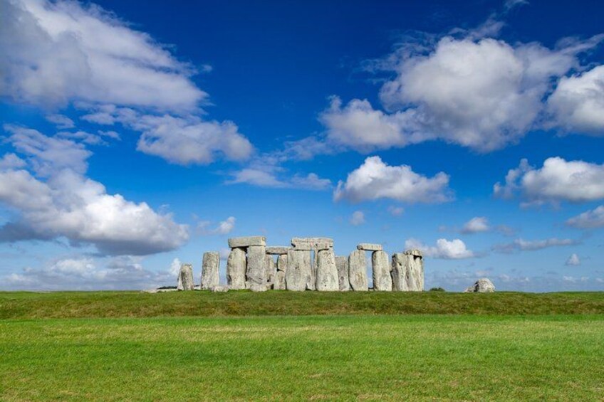 Stonehenge standing against a blue sky with clouds. 3