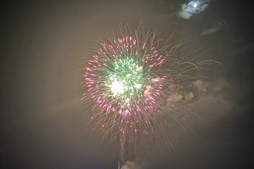 A firework display with green and red sparks. 2