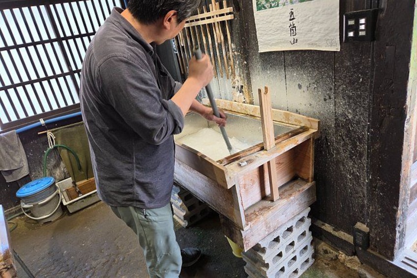 A person working with wooden tools in a workshop. 2