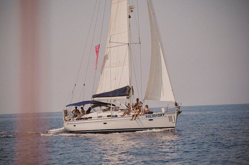 A sailboat with the registration POLO 16 GTY sailing on calm waters. 1