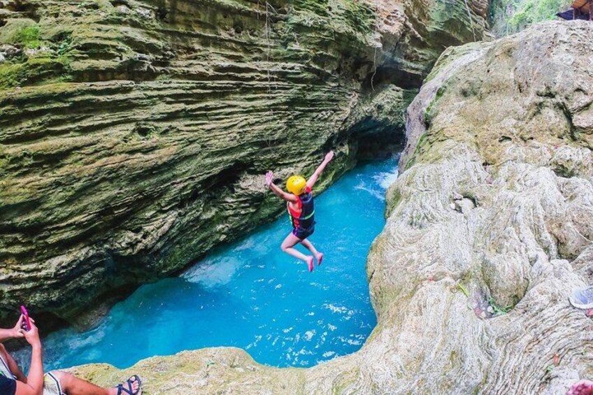 A person jumping from a cliff into a body of water. 5