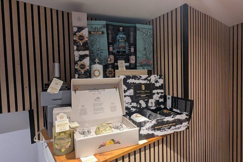 A display of various products in a store with striped walls. 2