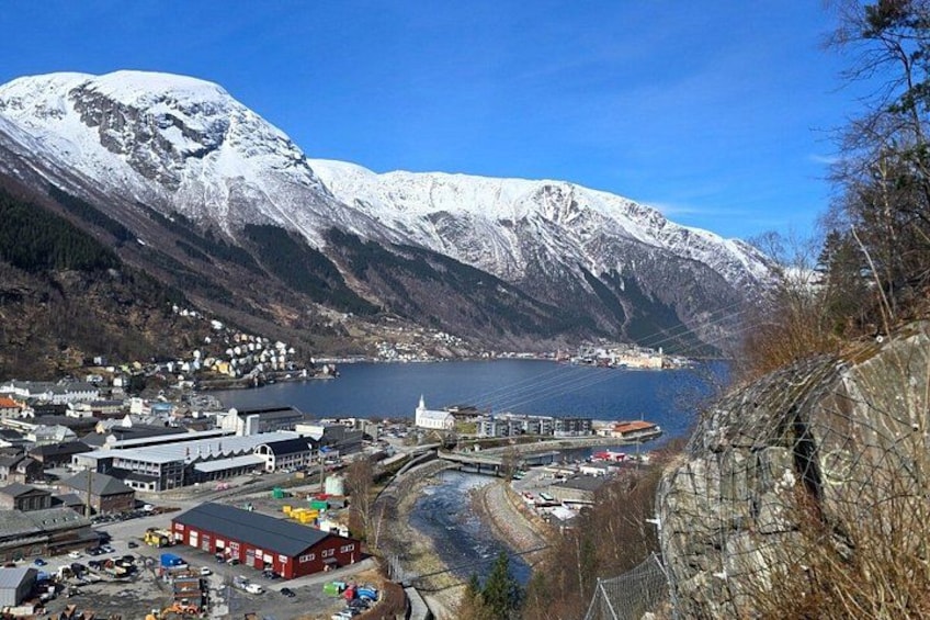 A town by a lake with mountains in the background. 2