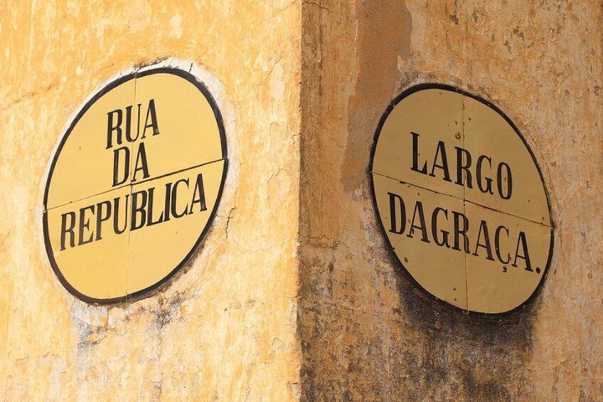 To runde skilte på en væg, hvor det ene viser 'Rua da Republica' og det andet 'Largo Dagraça'. 4