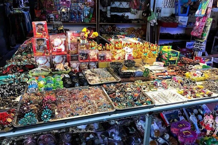A variety of colorful toys and collectibles displayed on a table in a store. 2