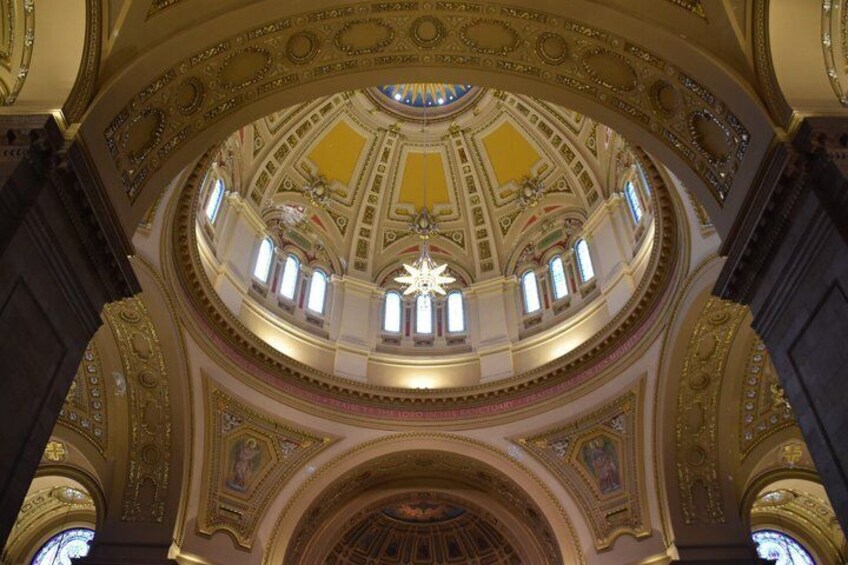 A grand, ornately decorated interior with a large, circular ceiling and a central star-like structure. 4