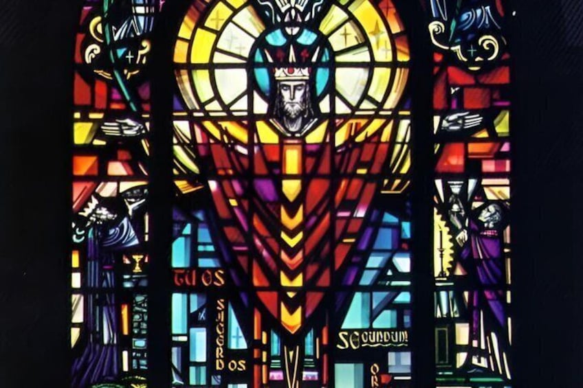 A stained glass window with a central figure, geometric patterns, and the word 'SACRED' visible. 3