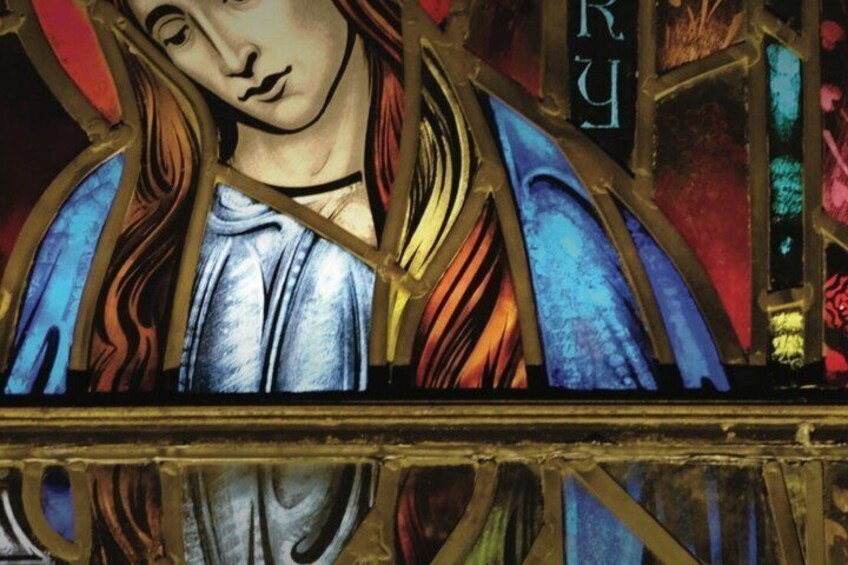 A stained glass window with a figure in blue and gold, and the word 'RURY' visible. 2