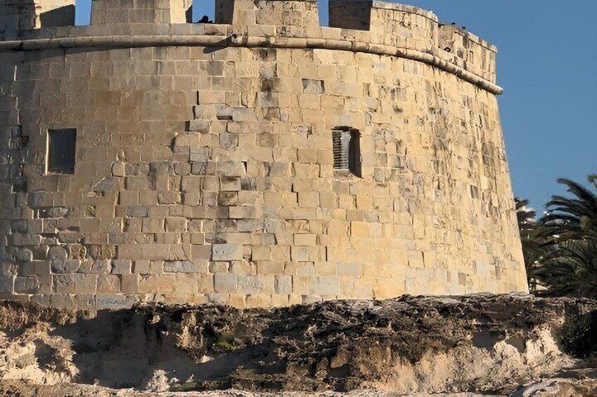 A stone tower with a rounded top and a small window. 4
