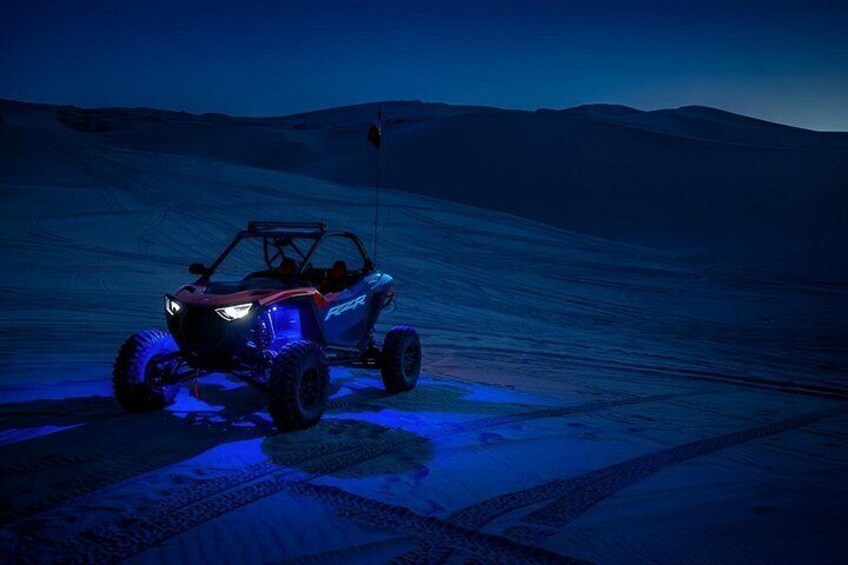 A vehicle on a snowy surface with a mountainous background. 2
