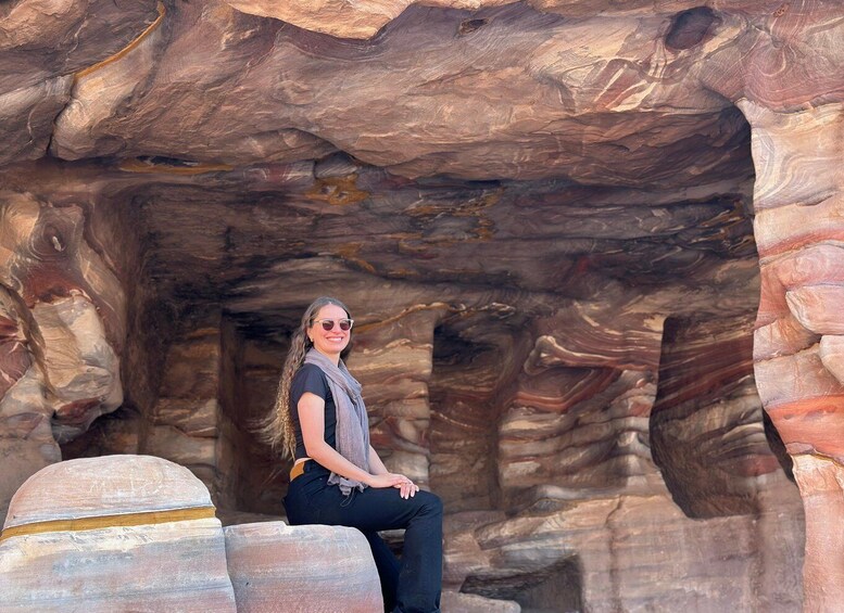 A person sitting in a natural rock formation. 4