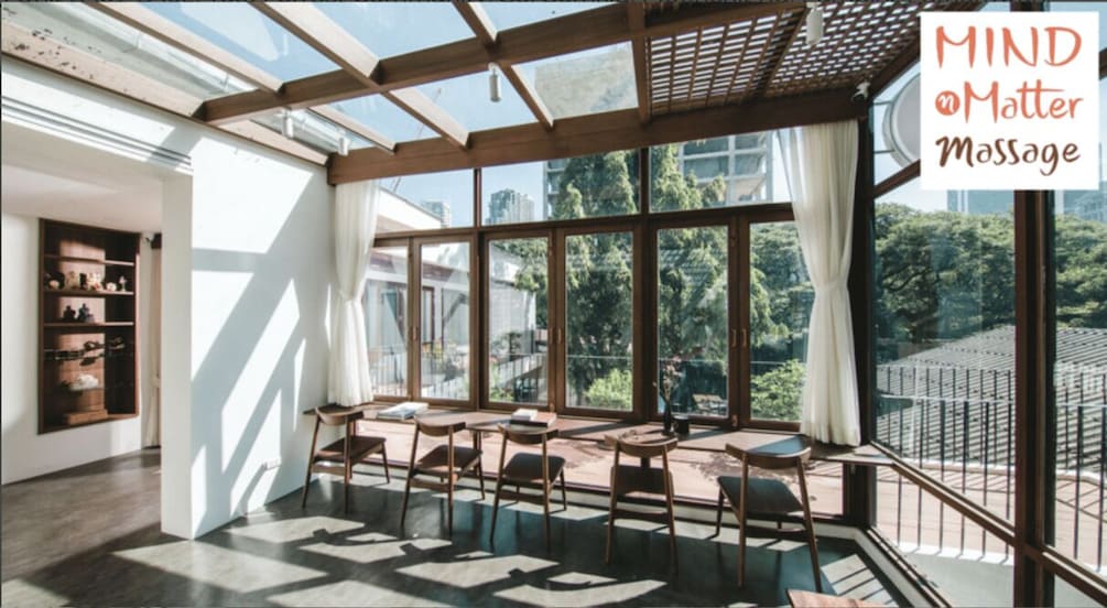 A modern interior with large windows, wooden furniture, and a view of a cityscape. 1