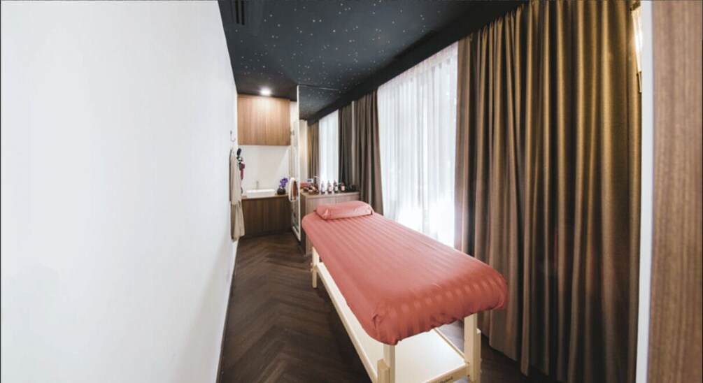 A room with a bed, a desk, and a window with curtains. 3