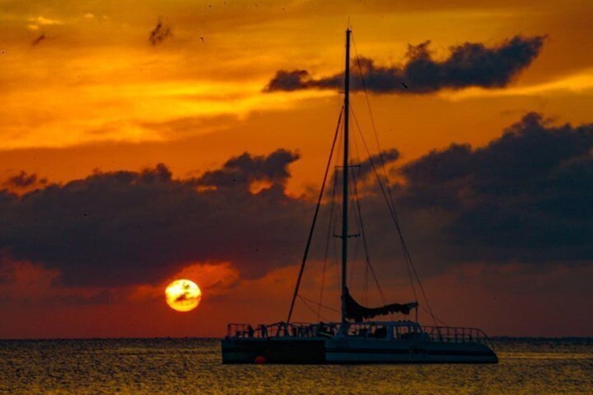 A sailboat on calm waters during sunset. 2