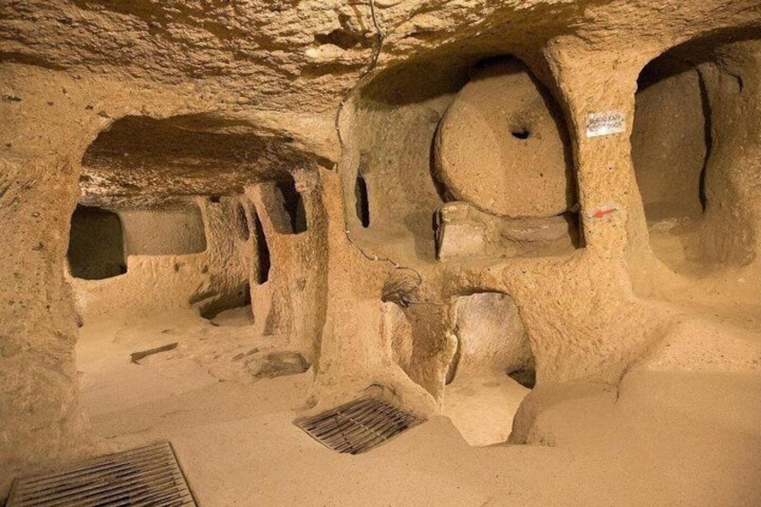 A cave with multiple chambers and a central drainage feature. 5