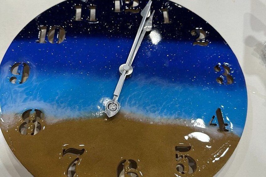 A clock with a beach scene design. 5