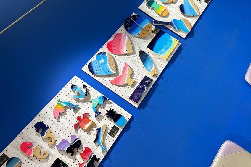 A blue floor with colorful, cut-out shapes arranged in rows. 2