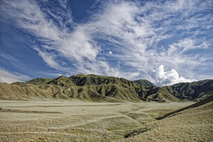 A desert landscape with rolling hills and a clear sky. 2