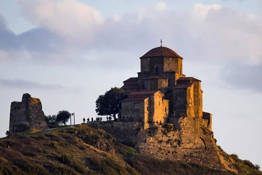 A historic church on a hill with ruins nearby. 5