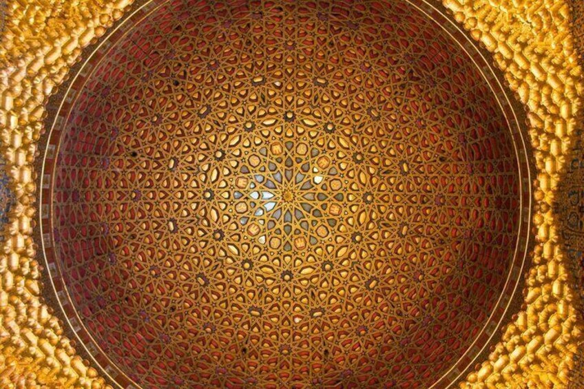 A detailed circular pattern with a central geometric design, surrounded by a textured border. 4