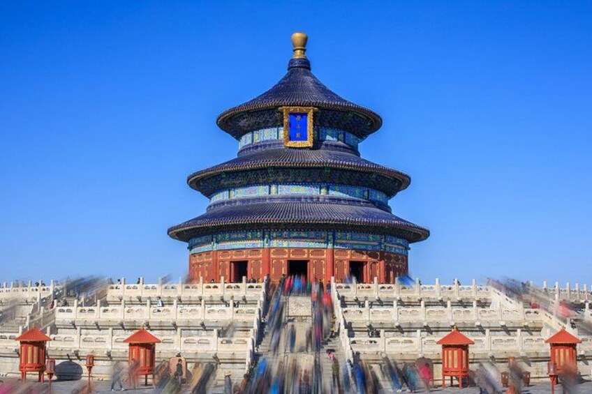 A traditional Chinese temple with a multi-tiered pagoda, red lanterns, and stone steps leading up to it. 1