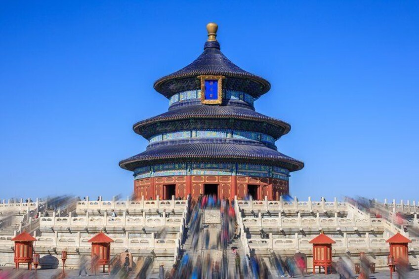 A traditional Chinese temple with a multi-tiered pagoda, a stone staircase, and red lanterns. 1