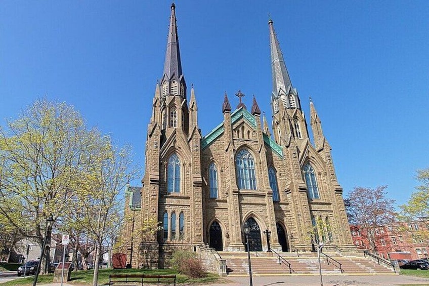 A large church with two tall spires and a green roof. 3